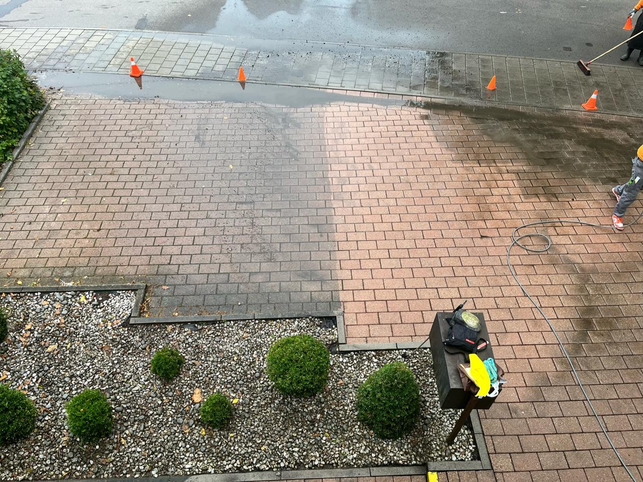 Pflasterreinigung bei der Arbeit – links verschmutzt, rechts bereits gereinigt